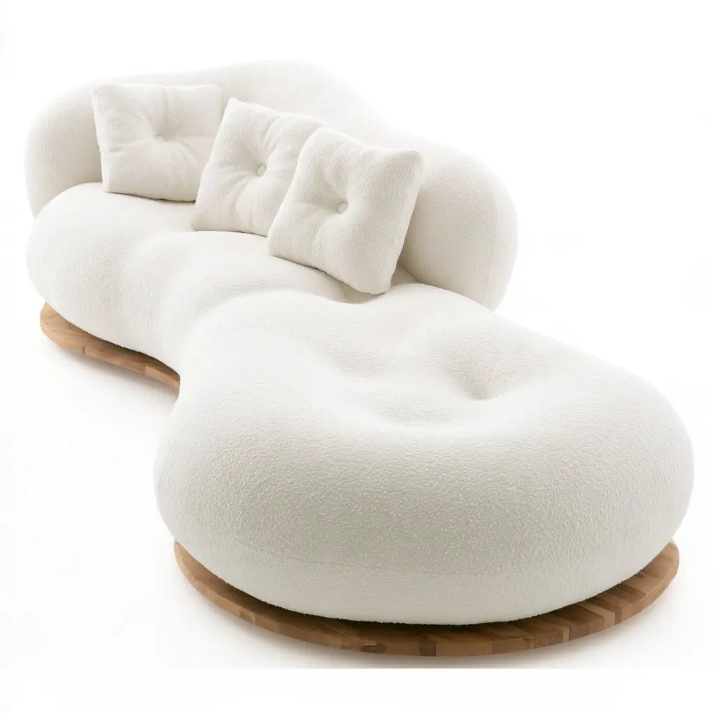 Canapé blanc à assise arrondie prolongée et base beige